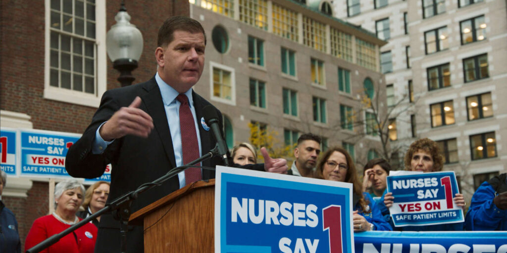 A still image from the documentary film "City Hall" featuring Boston Mayor Marty Walsh speaking at an event organized by the nurse's union
